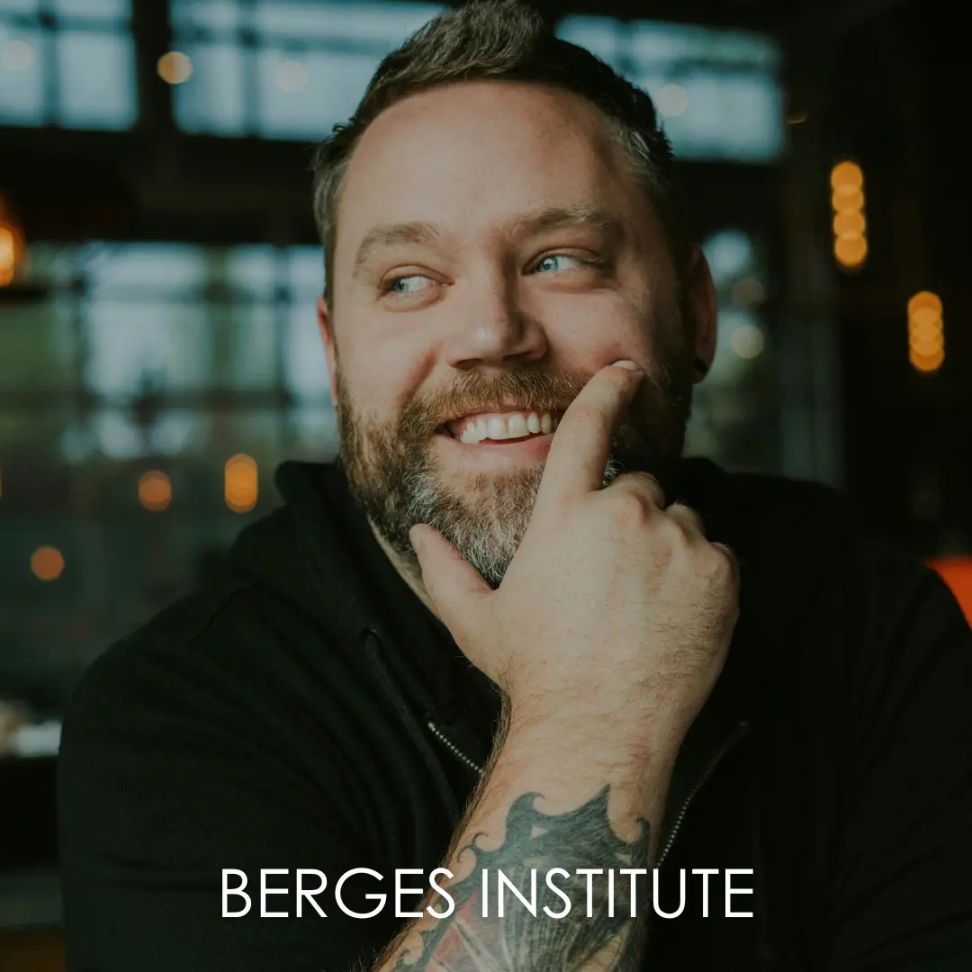 A bearded man smiling