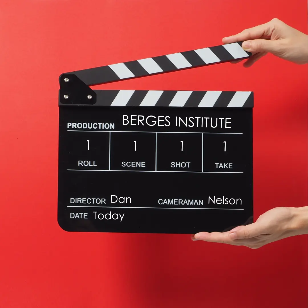 A sign that reads BERGES INSTITUTE ACT 1 SCENE 1